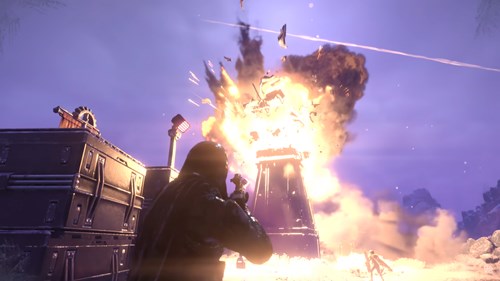 A building erupts into flames in Helldivers 2.